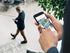 products/man_walking_and_using_phone_with_inset_close-up_of_phone_and_hands.jpg